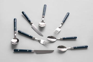 Stylish cutlery on grey background