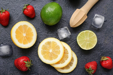 Juicer and ingredients for preparing strawberry lemonade on black background