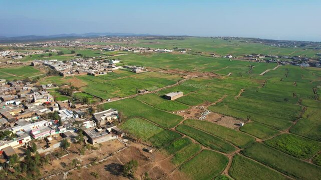 Aerial view of village between hills in Chakwal, Pakistan.