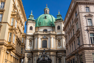 Fototapeta premium St. Peter's Church rising between buildings in Vienna