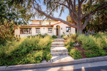 Countryside style homes surrounded with rich greenery and landscape with trees and blue sky within...