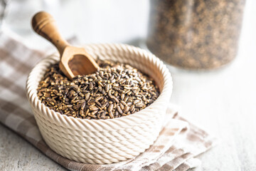 Milk thistle seeds in bowl on kitchen table.