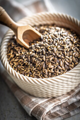 Milk thistle seeds in bowl on kitchen table.