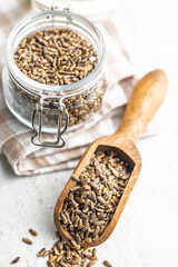 Milk thistle seeds in scoop on kitchen table.
