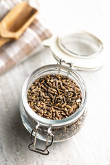 Milk thistle seeds in jar on kitchen table.