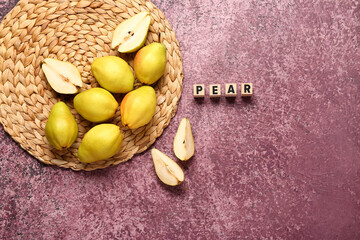Word PEAR and fresh fruits on purple background