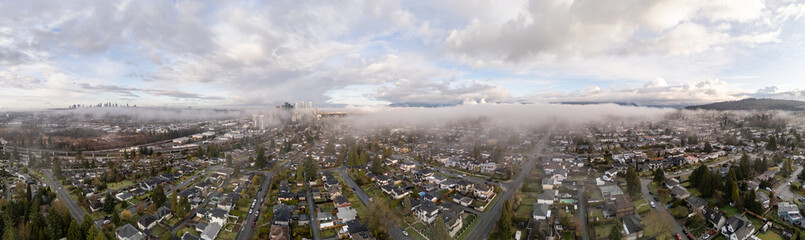 Obraz premium Aerial View of Burnaby Cityscape with Low Clouds and Residential Areas