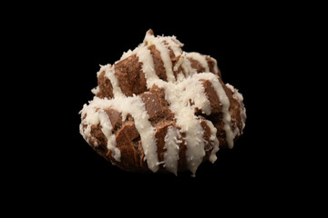Profiteroles with coconut cream on a black background.