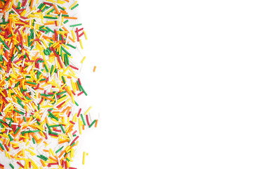 Sweet colorful sprinkles scattered on white background