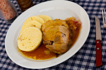Traditional old Bohemian dumplings served with sauerkraut and baked pork. Dish of Czech cuisine