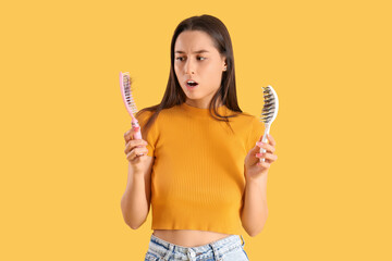 Shocked young woman with hair loss problem on yellow background