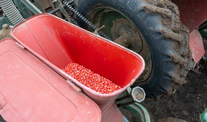 Farm machine planting seeds in a field during daytime