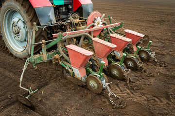 Farm machine planting seeds in a field during daytime