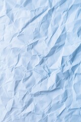 Obraz premium Close-up of a piece of light blue paper with a wrinkled texture, creating a graphic background