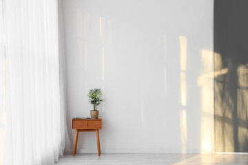 Interior of room with light curtain and table