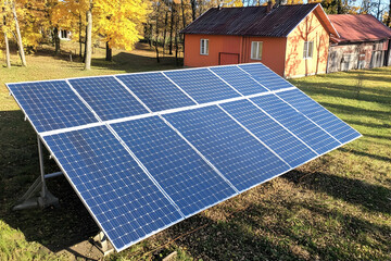 Solar panels on stand in park, autumn scenery, sustainable energy
