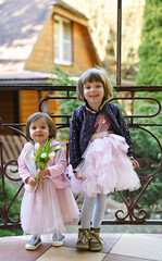 Sisters in fancy outfits with flowers