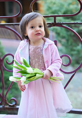 Little girl with purple tulips