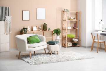 Stylish interior of living room with sofa, pouf and soft pillows