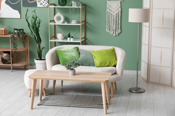 Interior of modern living room with comfortable sofa, olive pillows and wooden table