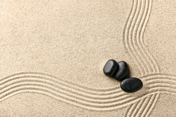 Spa stones on sand with lines