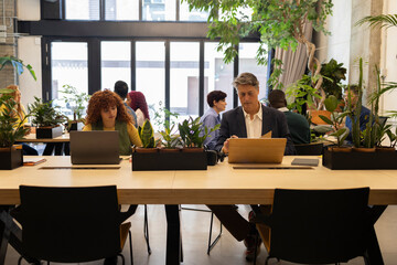 Business people working in modern green coworking space