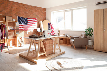 Interior of atelier with tailor's workplace and USA flags
