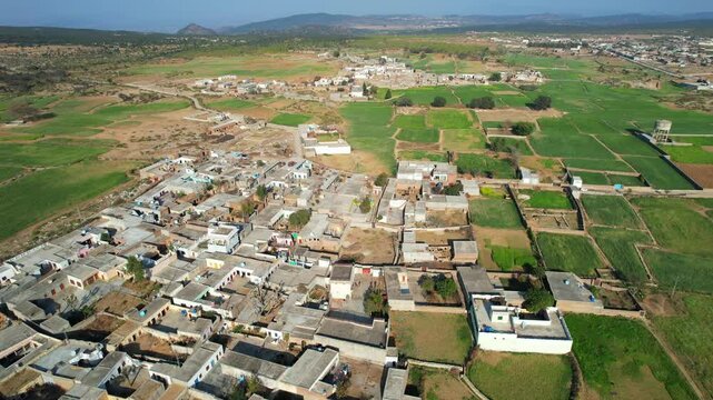 Aerial view of village between hills in Chakwal, Pakistan.