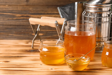 Jar, glass and bowl of sweet honey with dipper on wooden background