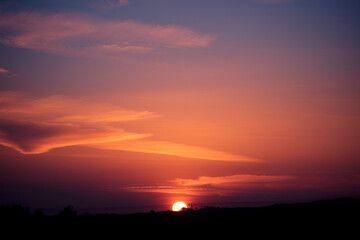 Fototapeta premium Beautiful sunset over the mountains with colorful sky and clouds