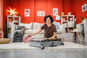 woman sit on floor and pack suitcase baggage prepare for vacation