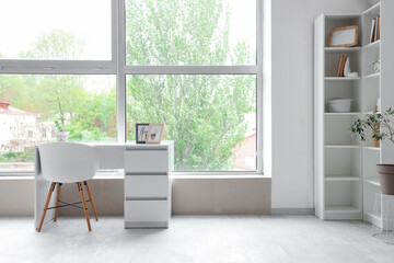 Interior of light room with workplace and big window