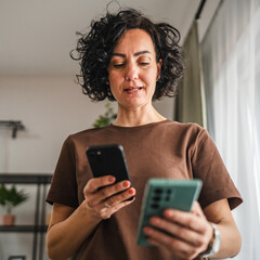 woman hold two mobile phones, use wireless connection technology