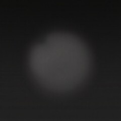 Neutral  and a blurred, dark circle define this minimalist image with a strong central focus and diffused edges