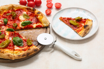 Composition with tasty pizza and cutter on light background