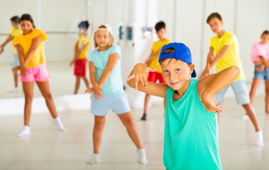 Group of active children dancing hip-hop dance in studio.