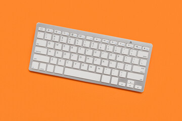 Modern keyboard on orange background