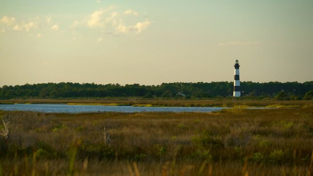 Rising 165 feet and painted with striking black and white stripes, picture-perfect Bodie Island Lighthouse at sunset.