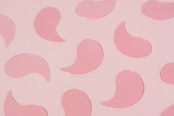 Close-up pattern pink hydrogel patches on pink isolated background. Concept of beauty products,...