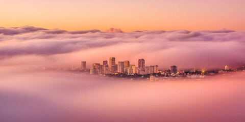 Obraz premium Sunrise city skyline veiled in a soft pink mist