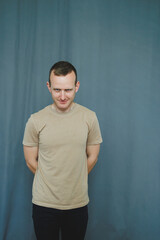 A contemplative young man is posed thoughtfully in front of a softly blended gradient background...
