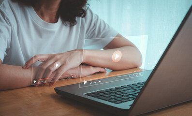 Online movie streaming. Young woman watching series on laptop computer with an imaginary video...