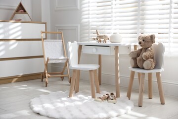 Different toys and stylish furniture in child's room
