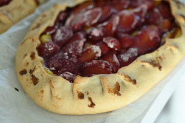 Delightful cherry galette cooling on the kitchen counter after a warm oven bake, inviting a taste of homemade sweetness