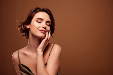 Fototapeta premium Photo of lovely young lady touch soft cheek face wear trendy khaki garment isolated on brown color background