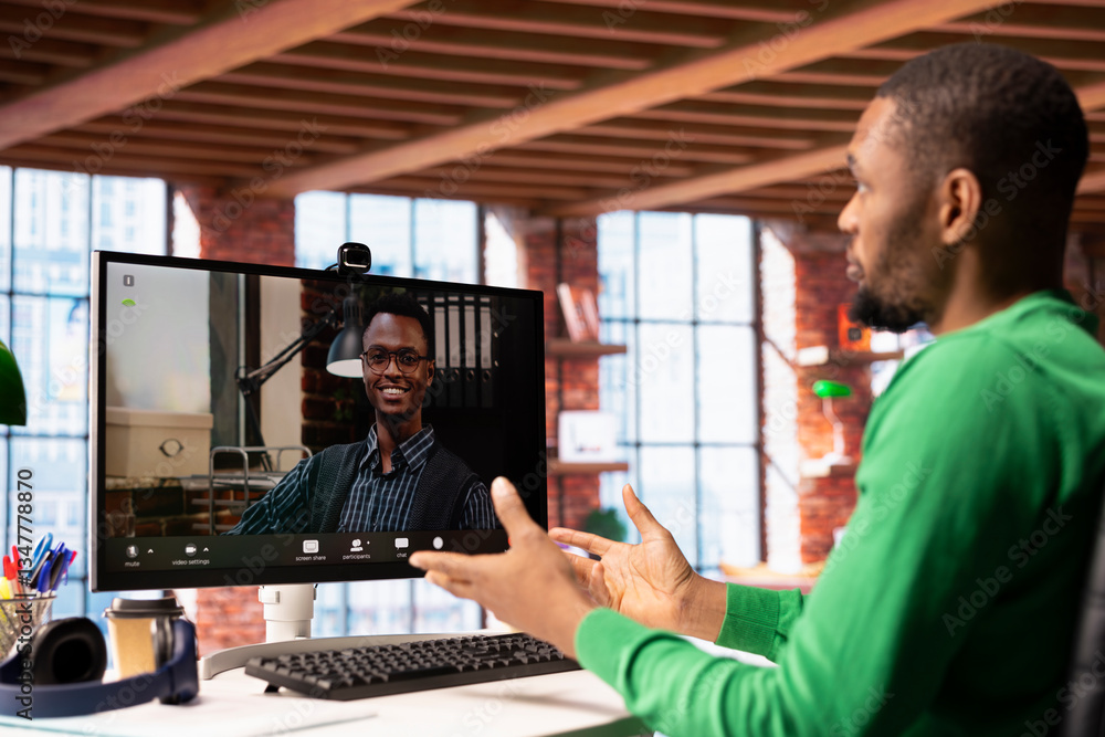 Poster remote worker calls manager remotely using internet videocall to ask for feedback on project progres