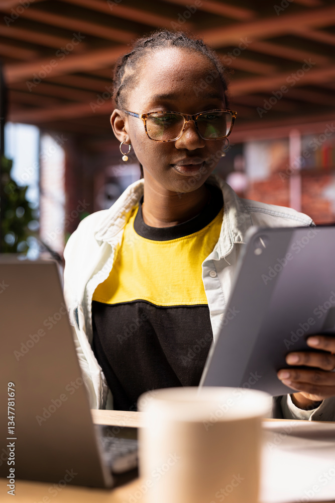 Poster woman in apartment using tablet to catch up with emails and reply back. person in home living room r