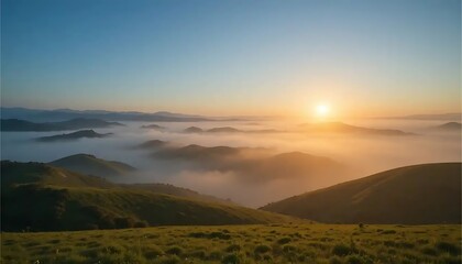 Sunrise Over Foggy Mountain Range with Green Grass Landscape