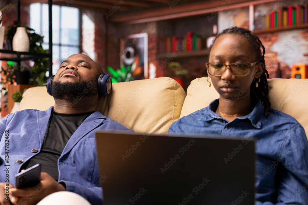 Poster person at home browsing internet on laptop and researching information online, accessing websites an
