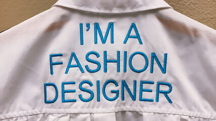 White shirt embroidered with I'm a Fashion Designer in teal Stylish simple and trendy